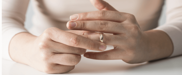 women holding her wedding ring talking to a divorce attorney